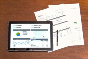 papers on desk showing marketing statistics
